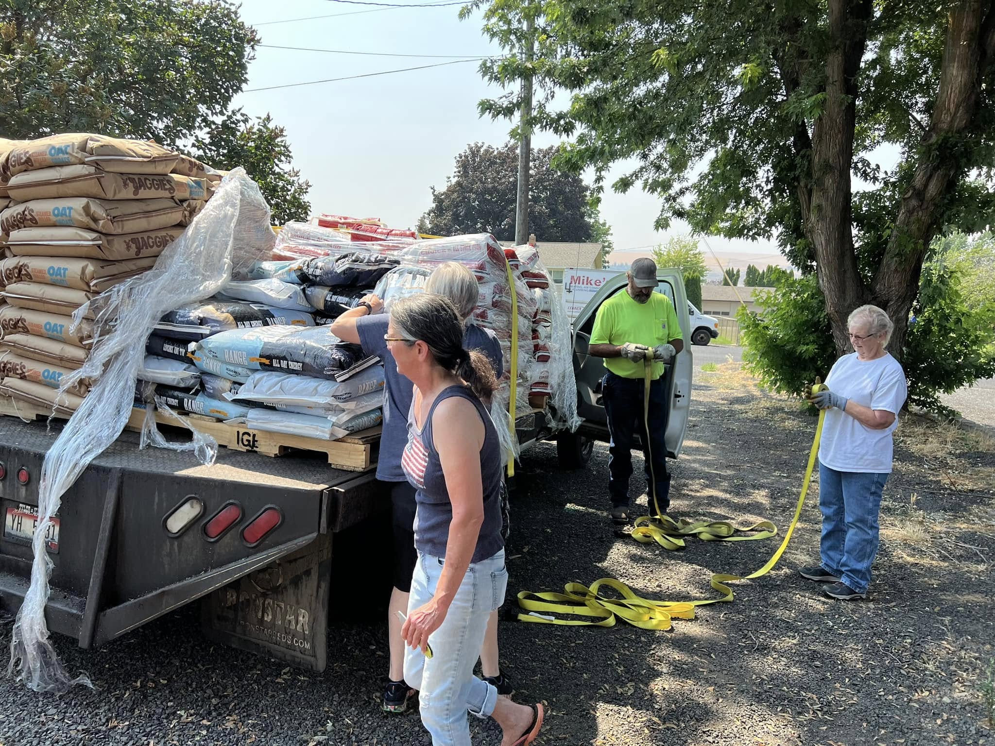 Volunteers unloading donated pet food and supplies