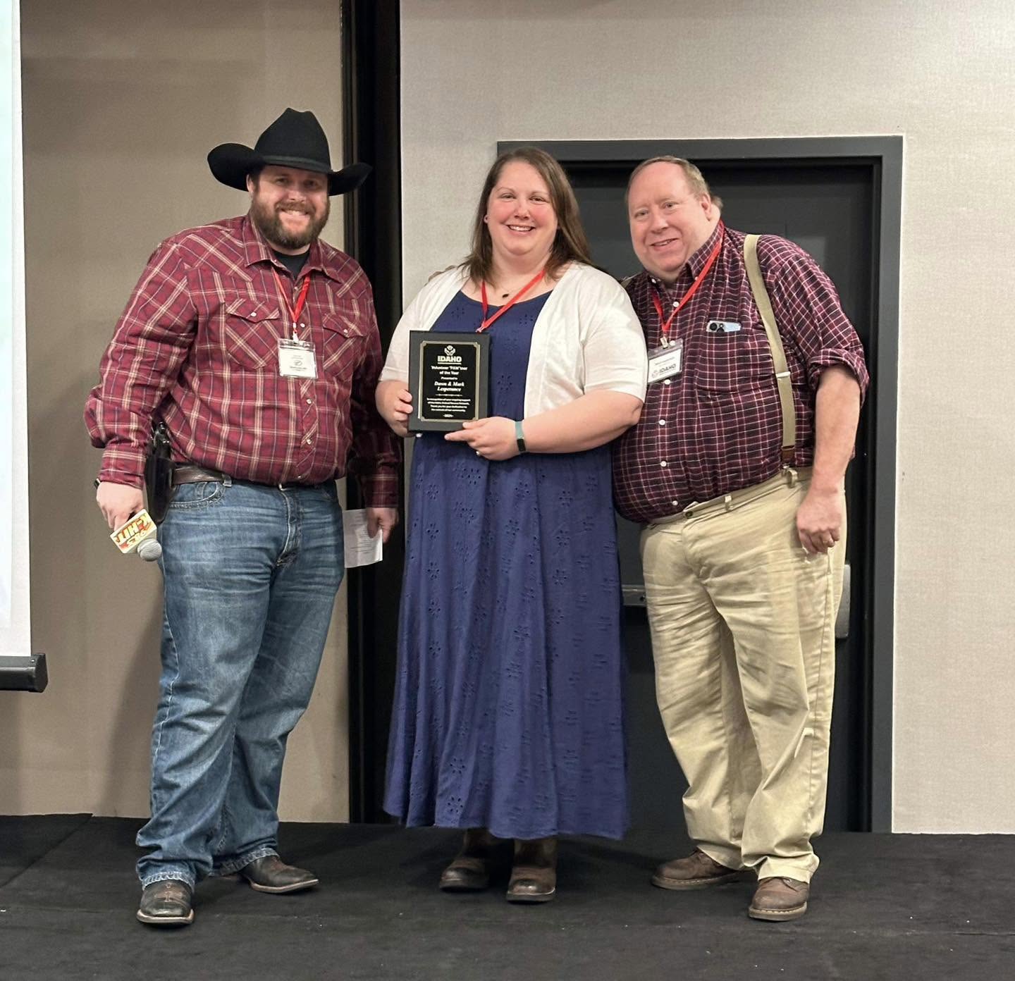 Three people celebrating a Pawtner Award presentation
