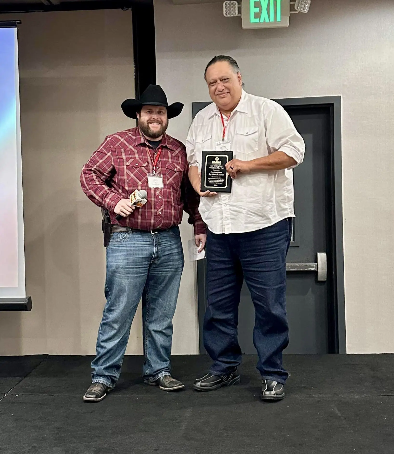 Two people holding an award plaque at an IARN event