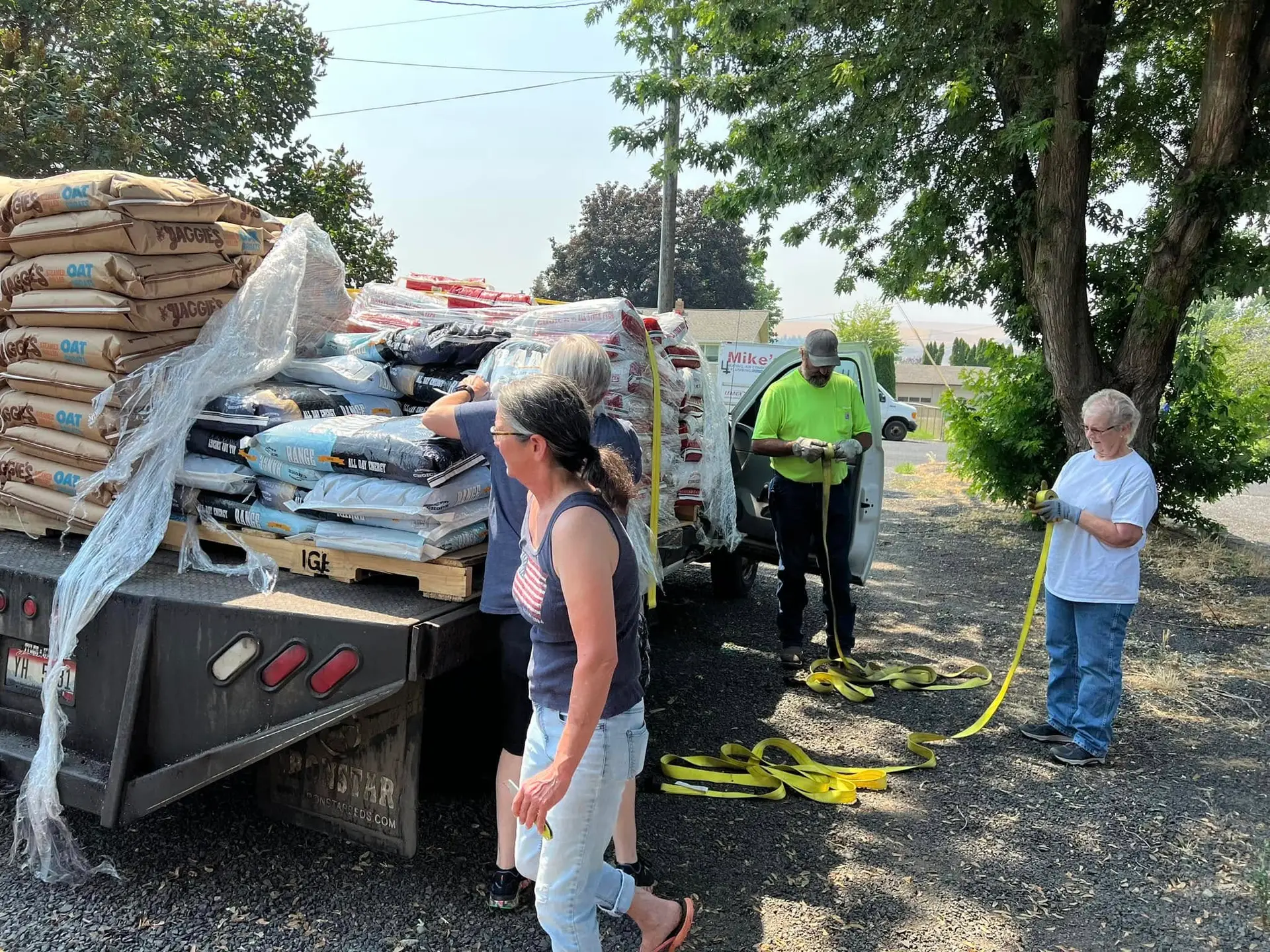 IARN volunteers unloading pallets of donated pet food from a truck