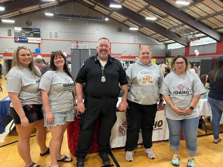 Idaho Animal Rescue Network team with a police officer at a community event